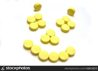 Smiling face tablets on white background