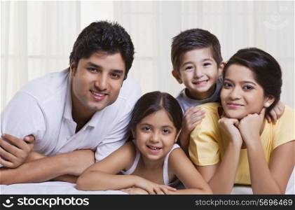Smiling family lying in bed