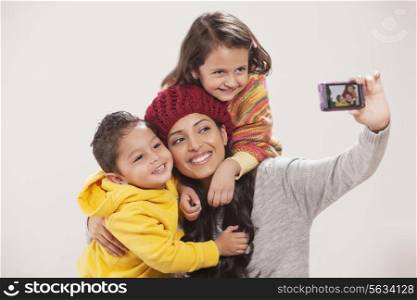 Smiling family photographing themselves