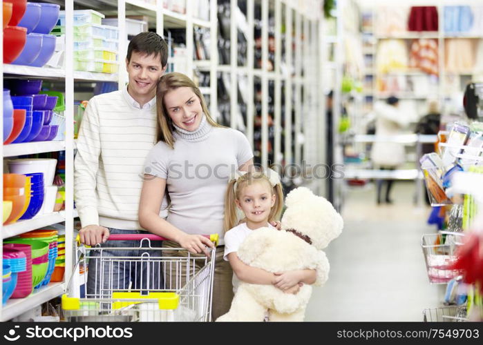 Smiling family wiah a child indoors