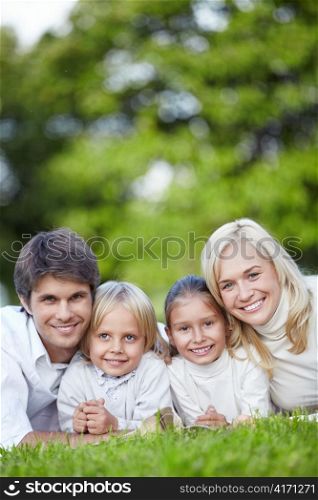 Smiling family with two children outdoors