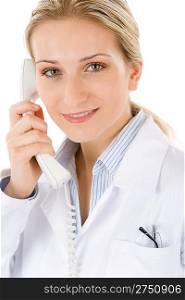Smiling female doctor on the phone on white background
