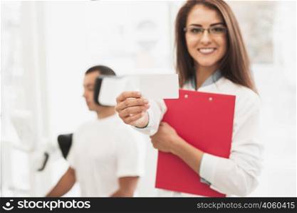 smiling female doctor showing card mock up