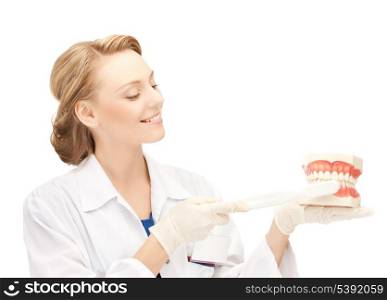 smiling female doctor with big jaws and toothbrush..