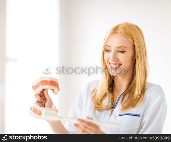 smiling female doctor with big jaws and toothbrush..