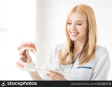 smiling female doctor with big jaws and toothbrush