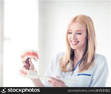 smiling female doctor with big jaws and toothbrush... doctor with big jaws