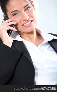 Smiling female executive on cellphone