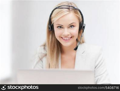 smiling female helpline operator with headphones and laptop