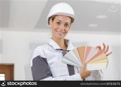 smiling female painter showing color swatches