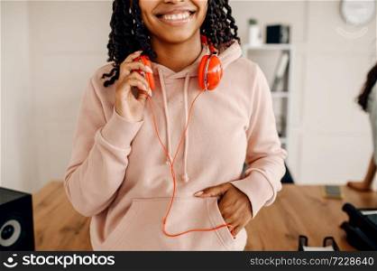 Smiling female person with headphones, music relaxation. Pretty lady in earphones relax in the room, sound lover resting. Female person with headphones, music relaxation