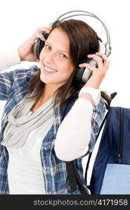Smiling female teenager enjoy music with headphones and baseball cap