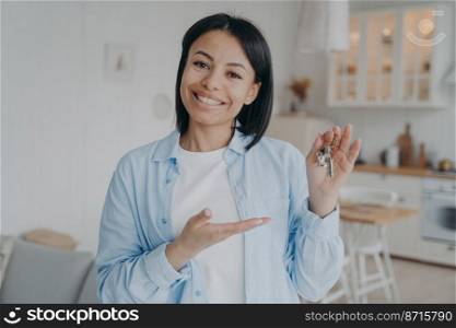 Smiling female tenant or homeowner showing keys to new home. Happy woman renter holding key to apartment, looking at camera. Real estate sale. Rental service, mortgage advertisement.. Smiling female tenant homeowner showing keys to new home. Real estate rental. Mortgage advertisement