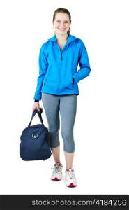 Smiling fit young woman with gym bag standing ready for fitness exercise