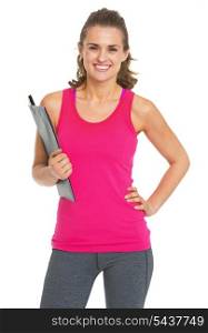 Smiling fitness trainer with clipboard