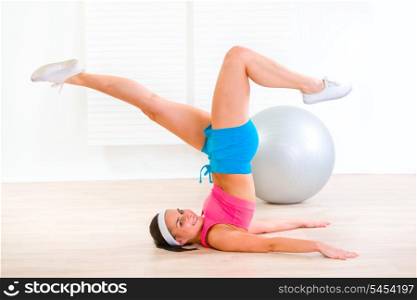Smiling fitness young girl working out at living room&#xA;
