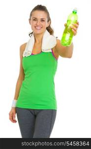Smiling fitness young woman giving bottle of water