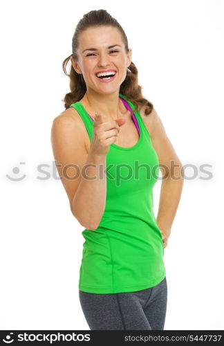 Smiling fitness young woman pointing in camera