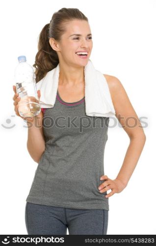 Smiling fitness young woman with bottle of water looking on copy space