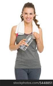 Smiling fitness young woman with towel and bottle of water