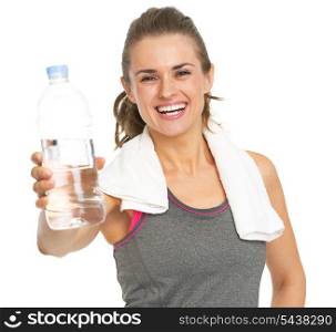 Smiling fitness young woman with towel giving bottle of water