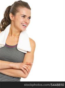 Smiling fitness young woman with towel looking on copy space