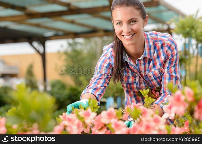 Smiling florist working in garden center looking at camera