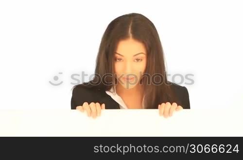 Smiling friendly attractive businesswoman holding a blank white board in her hands for your text or advertisement