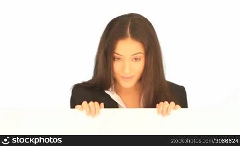 Smiling friendly attractive businesswoman holding a blank white board in her hands for your text or advertisement