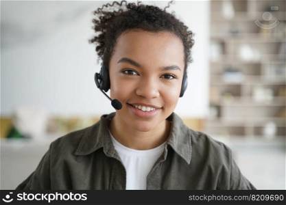 Smiling friendly mixed race girl student in headset, looking at camera, learning online. Headshot portrait of biracial teen girl in headphones with microphone. Distance education, elearning concept.. Smiling mixed race girl student in headset, looking at camera. Distance education, elearning