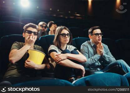 Smiling friends watching 3d movie in cinema. Showtime, entertainment industry technologies. Smiling friends watching 3d movie in cinema