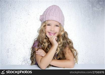 Smiling gesture little girl winter pink cap portrait silver background