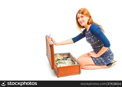 smiling girl and a suitcase full of money