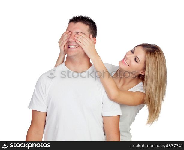 Smiling girl covering his boyfriend's eyes to surprise him isolated on a white background