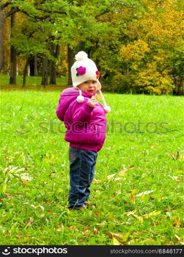 smiling girl in a white hat. smiling girl in a white hat on a background of green meadows