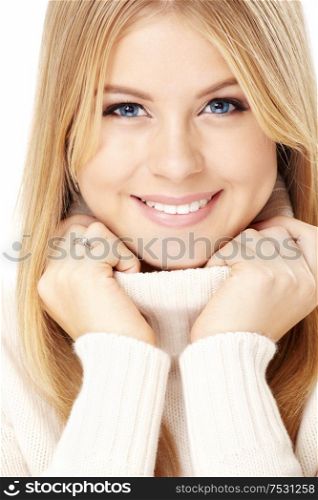 Smiling girl in the white sweater, isolated