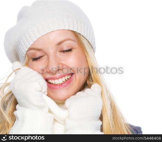 Smiling girl in winter clothes enjoying soft scarf
