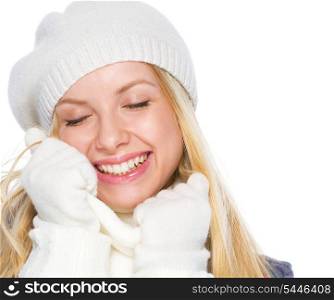 Smiling girl in winter clothes enjoying soft scarf