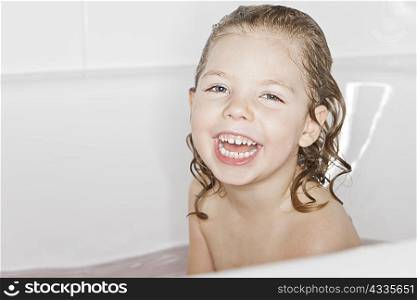 Smiling girl laughing in bath