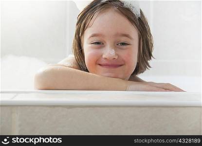 Smiling girl siting in bath