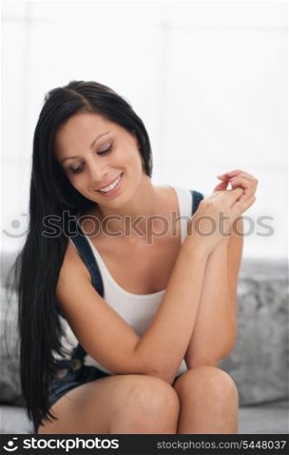 Smiling girl sitting on couch in living room