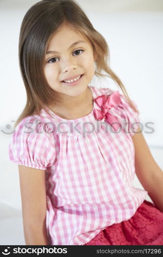 Smiling Girl Sitting On Sofa