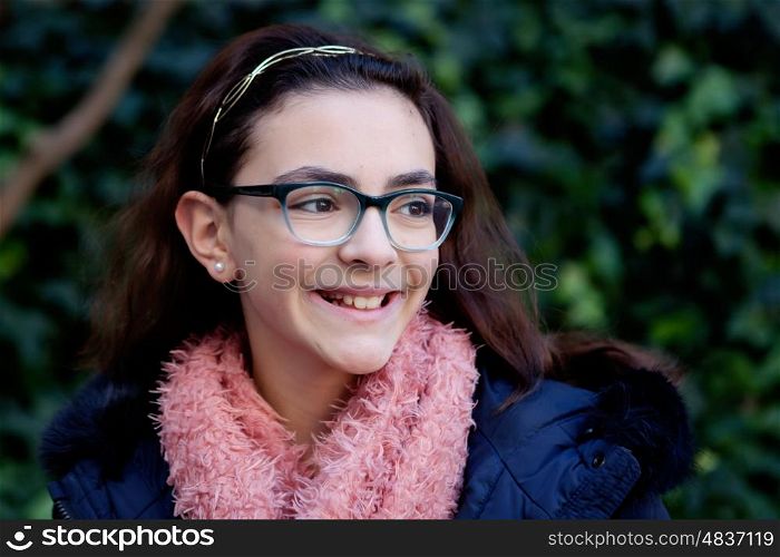 Smiling girl with 12 years old in the garden at winter