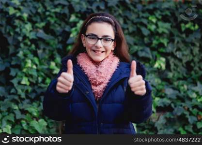 Smiling girl with 12 years old in the garden at winter