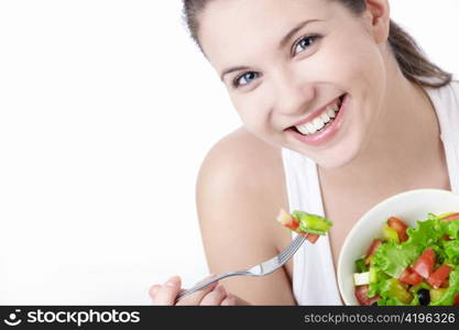 Smiling girl with a salad on a white background