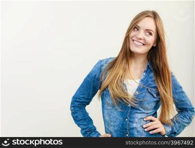 Smiling girl with arms on hips. . Smiling girl with arms on hips. Young woman in jeans jacket. Fashion beauty leisure concept.