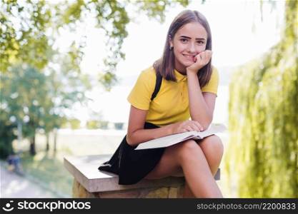 smiling girl with book park