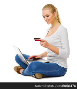 Smiling girl with laptop and plastic card isolated