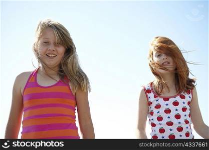 Smiling girls hair blowing in wind