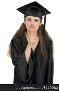 Smiling graduation student girl showing shh gesture